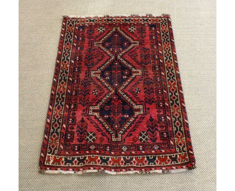 A Late 20th Century Shiraz Rug A Late 20th Century Shiraz Rug, with repeated geometric detail on red ground.170cm long, 111cm