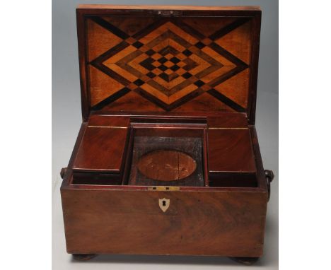 A 19th Century Victorian mahogany tea caddy of rectangular form having a hinge lid with ring handles and inlaid bone escutche