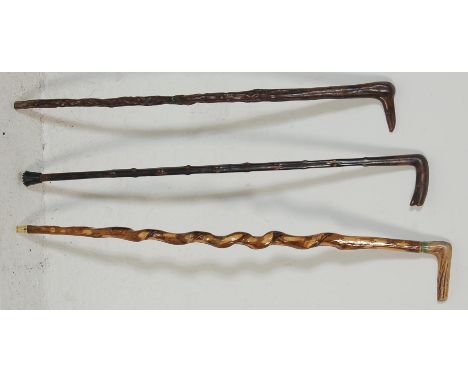 A collection of three late 20th Century wooden walking sticks / canes to include a bone handled walking stick with a barley t