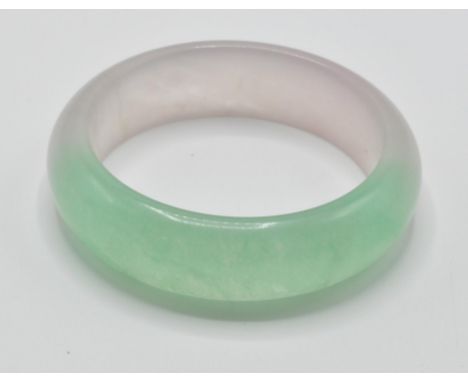 A 20th century ladies oriental Chinese green jade colour bangle, having half moon shape. Measures 8cm diameter, weight: 79g.