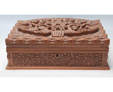 A vintage 20th Century finely carved fruitwood jewellery box having bird and floral decoration throughout with a repeating lo