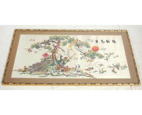 A retro vintage late 20th Century Chinese needle work embroidery fabric picture of peacocks, parrots, cockerels, cormorants a