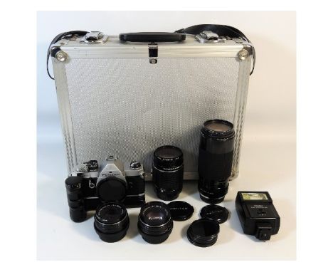 A Pentax MX 35mm film camera, a Takumr 135mm lens, a Tokina AT-X-50-250mm lens &amp; other accessories