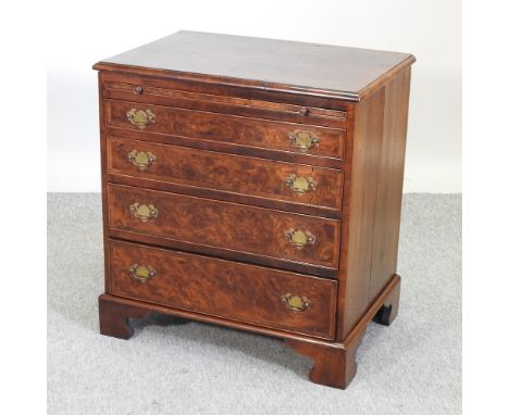 An 18th century style burr walnut chest, of small proportions, fitted with a brushing slide, over four drawers, on bracket fe
