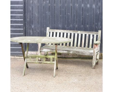 A teak slatted garden bench, 160cm, together with a folding garden table, 135 x 85cm