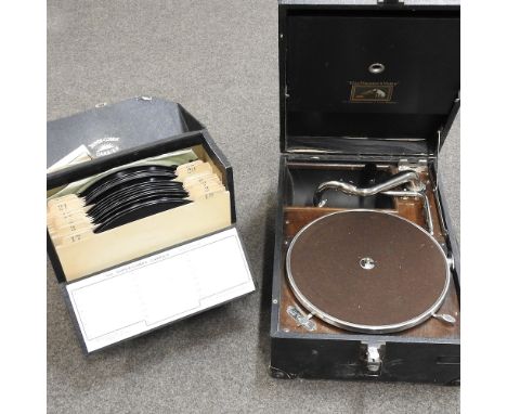 An HMV record player, together with a box of vintage records