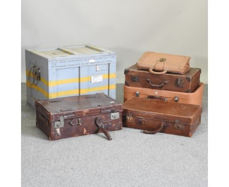 A collection of vintage leather suitcases and a wooden trunk