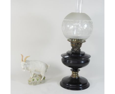 A brass hanging oil lantern with a glass shade, together with a black oil lamp and a Harper Shebeg Isle of Man model of a goa