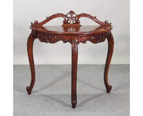 A hardwood bow front side table, on cabriole legs, 87cm