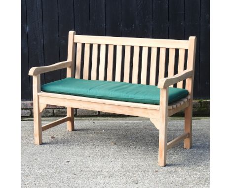 A teak slatted garden bench, with a loose cushion, 150cm
