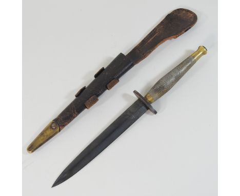 A World War II commando knife, No 2, the blade inscribed SS fighting knife, in a leather scabbard, 31cm long overall