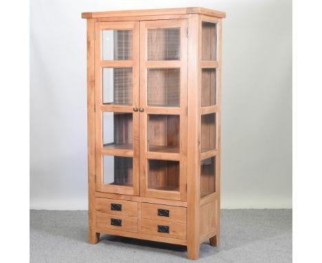 A modern glazed light oak cabinet, 98cm