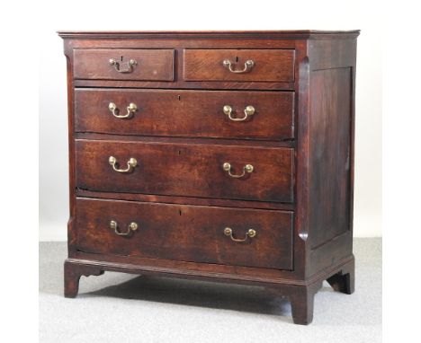 A late George III oak chest of drawers, containing two short over three long drawers, on bracket feet, 108cm