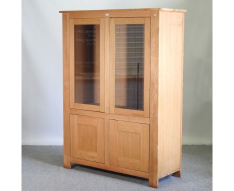 A modern light oak glazed cabinet, 134cm