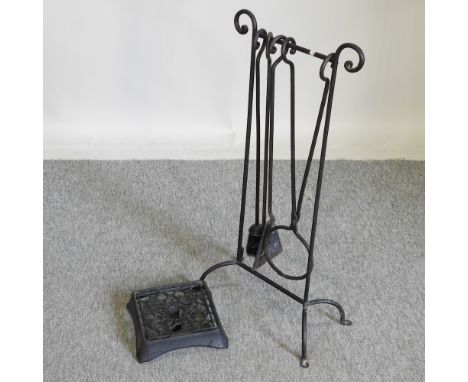 A cast iron trivet by Le Creuset, 24cm, together with a set of black painted iron fire tools
