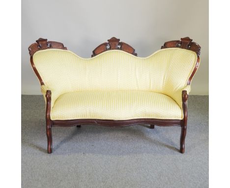 A Victorian carved and yellow upholstered children's show frame sofa, of small proportions, 140cm