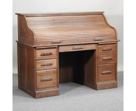 A mid 20th century light oak tambour top pedestal desk, 138cm