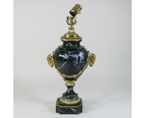 A green painted metal table lamp, with ram's head decoration, 43cm high