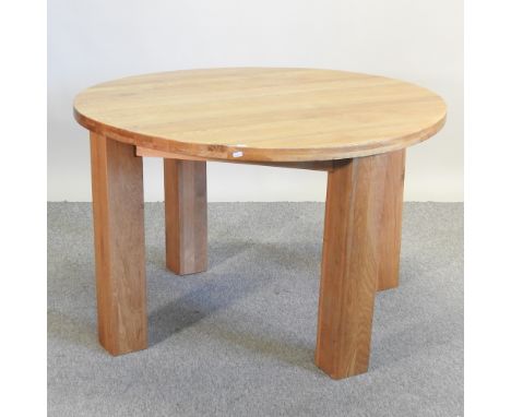 A modern light oak circular dining table, 115cm diameter