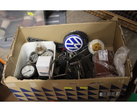Box of car badges, Vauxhall, Nissan, Corsa, etc and fuel dials, headlight covers, etc