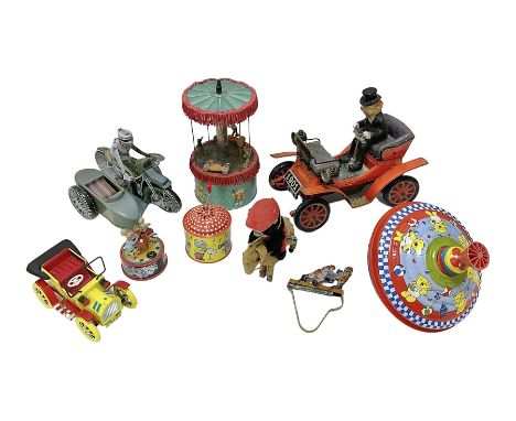 Nine tinplate and clockwork models to include battery operated ‘Antique Car’ by Toys Namura of Japan, Jock-O-Panda wind-up Pa