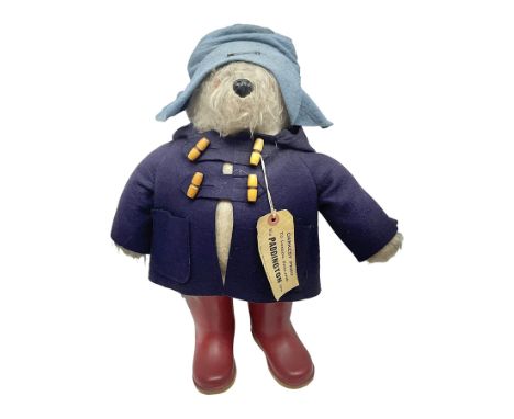 Paddington Bear teddy with amber eyes, blue felt hat and coat, red Dunlop boots and original label, H48cm Condition Report:So