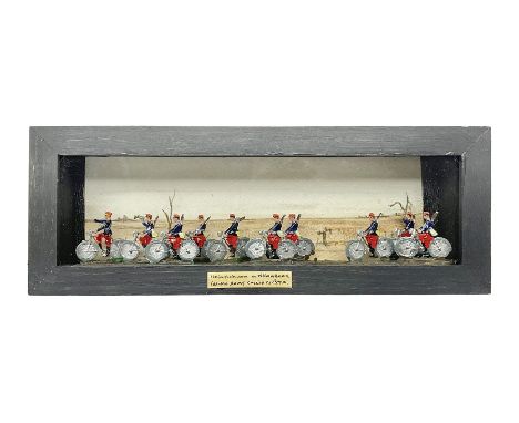Ten Hinrichsen of Nuremberg flat figures cased French cyclists, with hand painted back drop, paper label to the front marked 