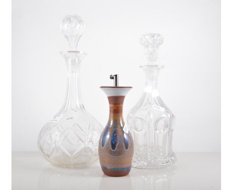 Cut glass globe and one decanter, with stopper, height 31cm, three other decanters and an oil pot, (5).