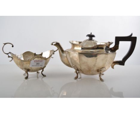 Silver three piece teaset, scrolled borders and feet, comprising teapot, ebonised handle and finial, CCP London 1905, milk ju