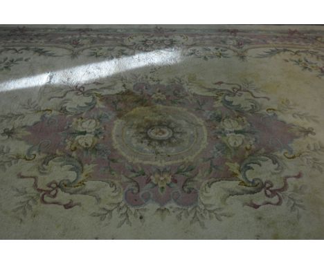 Indian wool carpet, central floral and scrolled medallion, on a pale ground, within border, 500cm x 330cm.