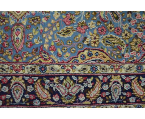 Persian pattern small carpet, pale ground floral medallion, blue field with stylised flowers within spandrels, floral border,