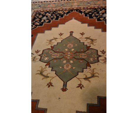 Persian pattern carpet, central lozenge medallion, multi ground within dark blue spandrels, meandering floral border, 420cm x