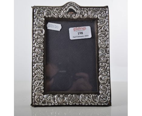 Rectangular photograph frame, embossed silver mount, KF Limited, London 1982, easel back, height 18.5cm, the aperture 12.5cm 