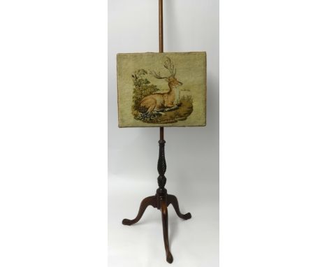 A mahogany tripod pole screen with tapestry Stag decoration.