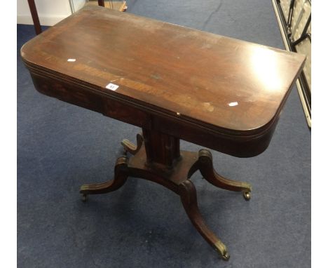 A 19th Century mahogany fold over card table on pedestal base.