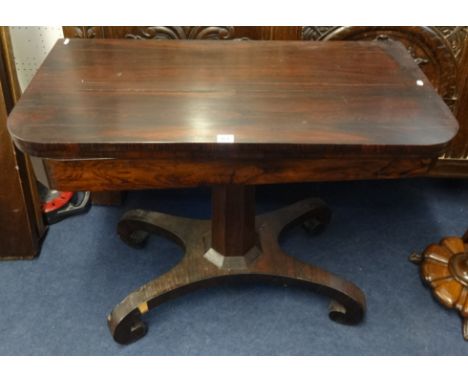 A 19th Century rosewood fold over card table on pedestal base.