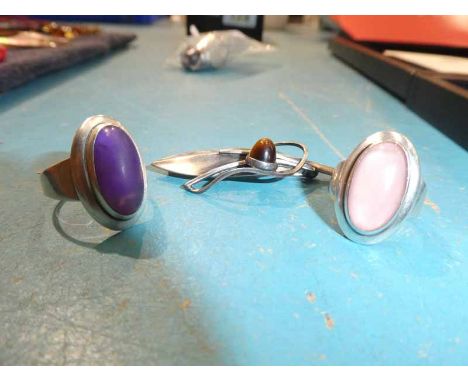 Neils Erik From (Danish, 1908-1982); a cabochon rose quartz dress ring, size K 1/2, and a similar amethyst example by the sam