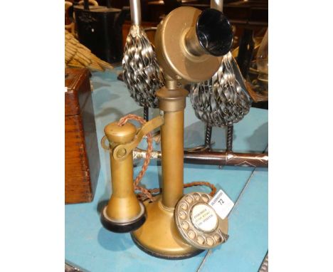 A brass candlestick telephone