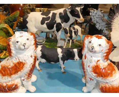 A large cast resin model cow and calf, resin cow and a pair of Staffordshire pottery fireside Spaniels (4)