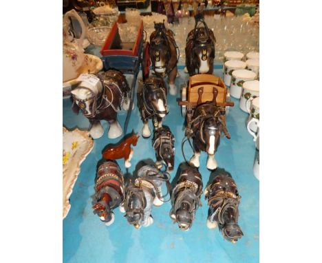 Eleven pottery cart horses in gears and two model carts
