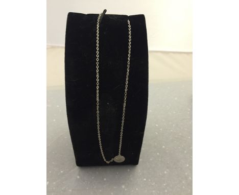 A silver diamond set pendant and chain