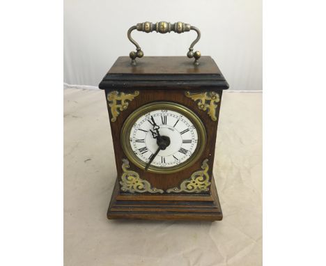 A 19th century French alarm carriage clock in a wooden and brass case