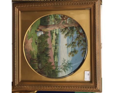 A framed painted terracotta ceramic plate depicting a landscape