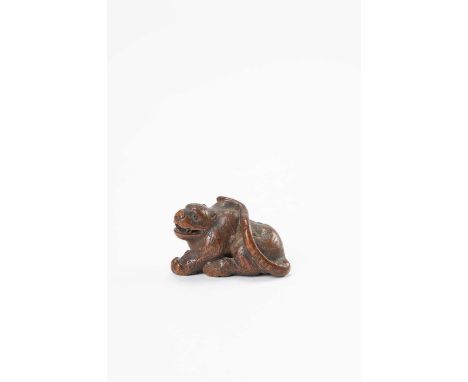 A JAPANESE WOOD NETSUKE OF A TIGEREDO PERIOD, 18TH/19TH CENTURYThe crouching beast with its mouth slightly open revealing sha