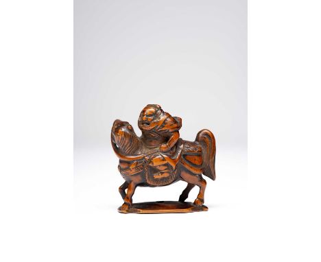 A JAPANESE WOOD NETSUKE OF GENERAL GENTOKUEDO PERIOD, 18TH OR 19TH CENTURYThe armour-clad warrior depicted riding his horse T
