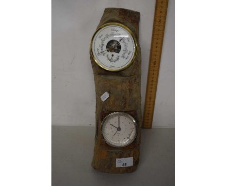 A modern wood mounted barometer and clock combination