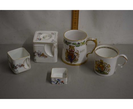 A vintage porcelain cube teapot and accompanying jug and sugar basin plus two further royal commemorative mugs
