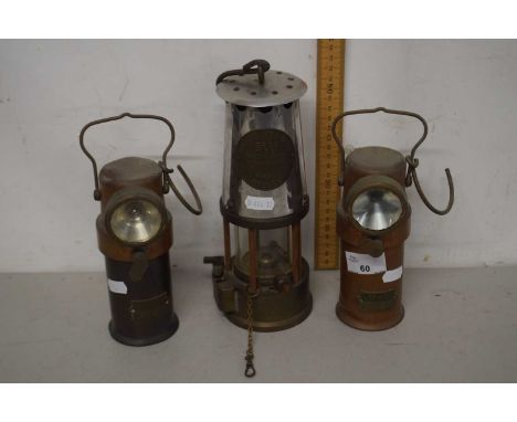 A vintage miners lamp marked Protector Lamp Lighting, Eccles together with two further smaller copper lamps marked CEAG Ltd, 
