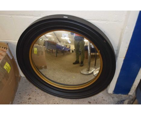 Reproduction convex porthole style mirror in gilt and ebonised frame