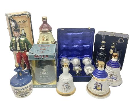 Bells, Scotch whisky, in five Wade ceramic decanters, together with Irish Mist  in novelty decanter, an empty Lambs Navy Rum 
